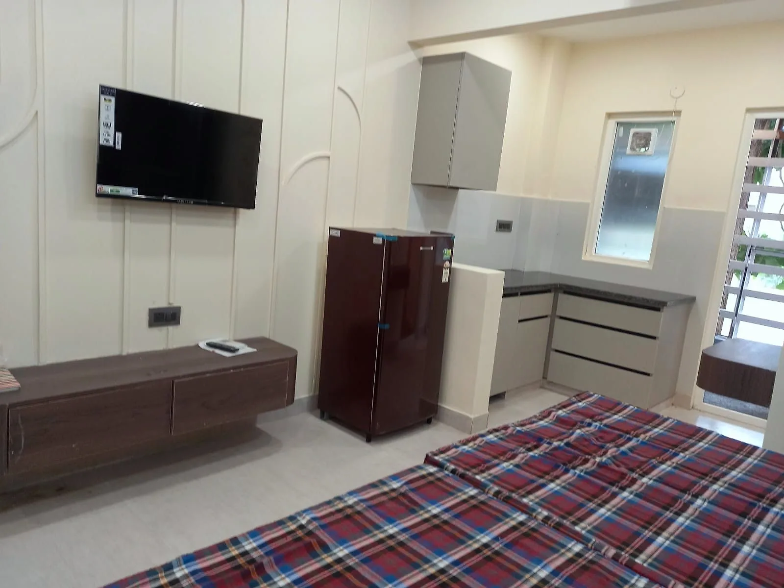 Furnished 1 RK with panelled TV wall, refrigerator, granite kitchen counter and double bed